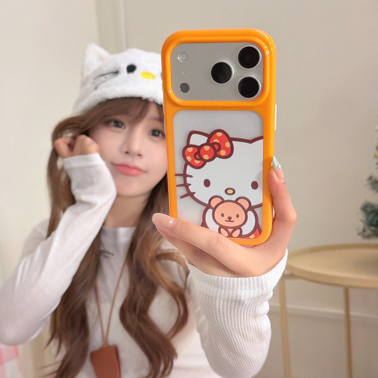 Orange-bordered Kitty hugging a bear rounded phone case