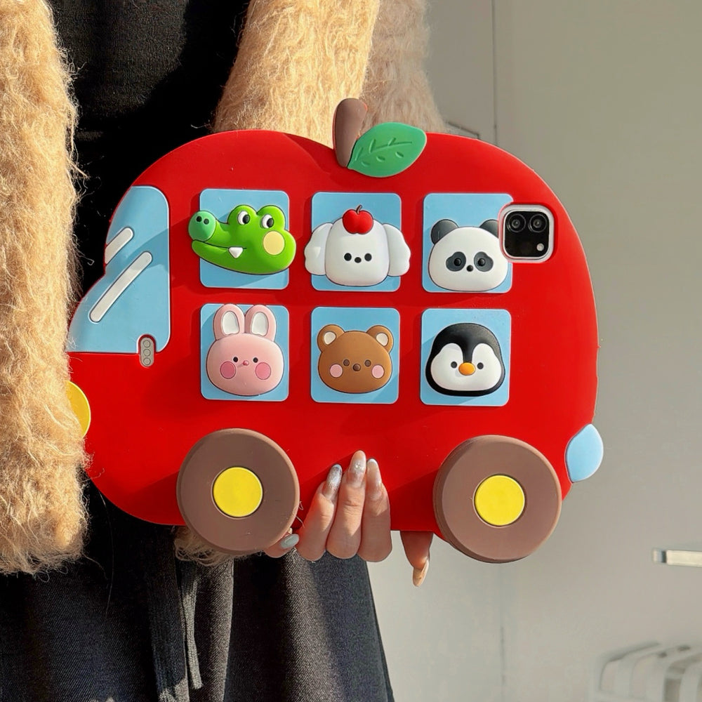 Close-up front view of the 3D cartoon animal iPad cover being held up, showing the thick protective red silicone frame and detailed animal figures.