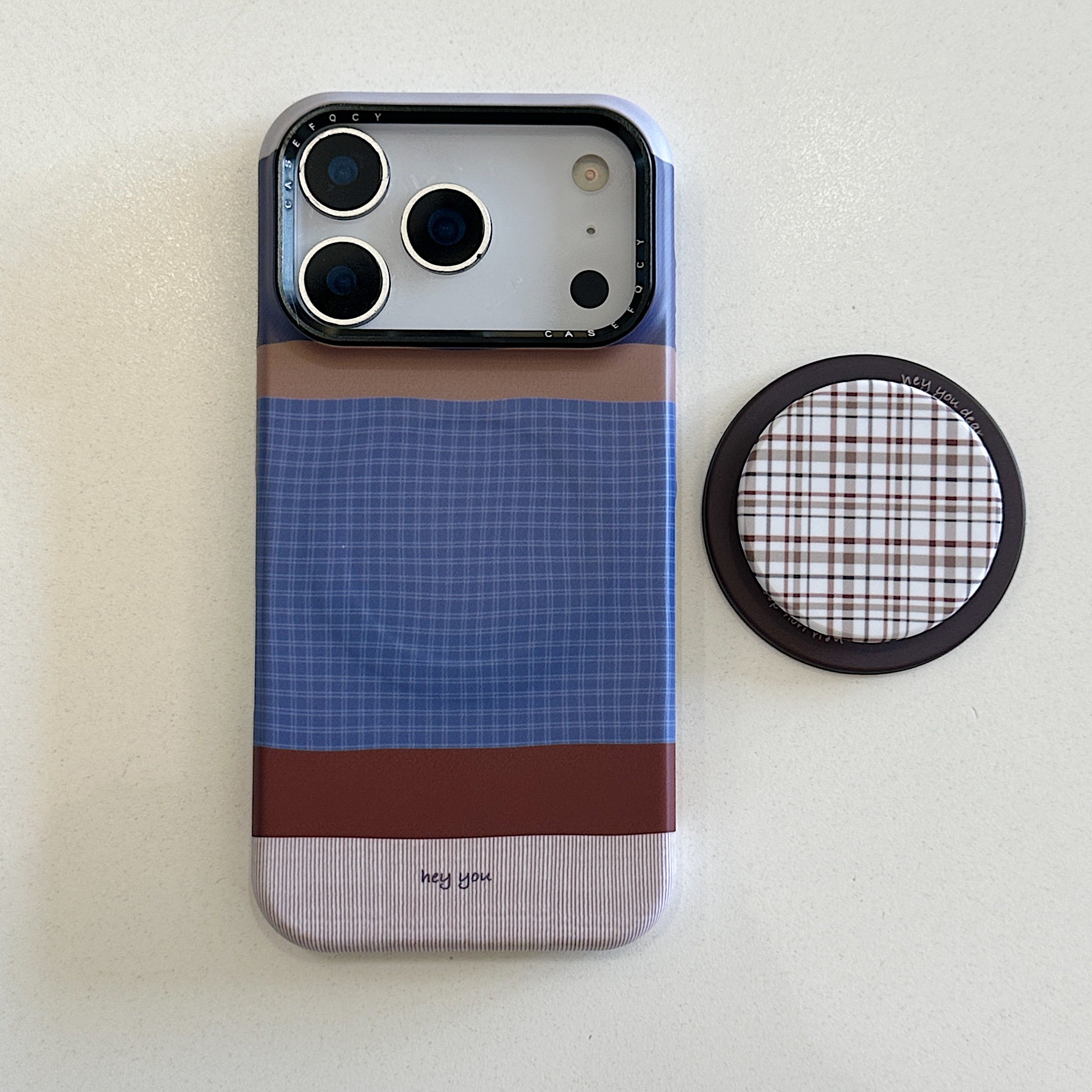 Brown, blue, and white striped phone case with magnetic stand