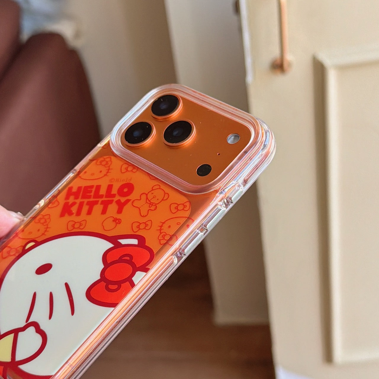 Orange-toned Kitty side profile rounded airbag phone case