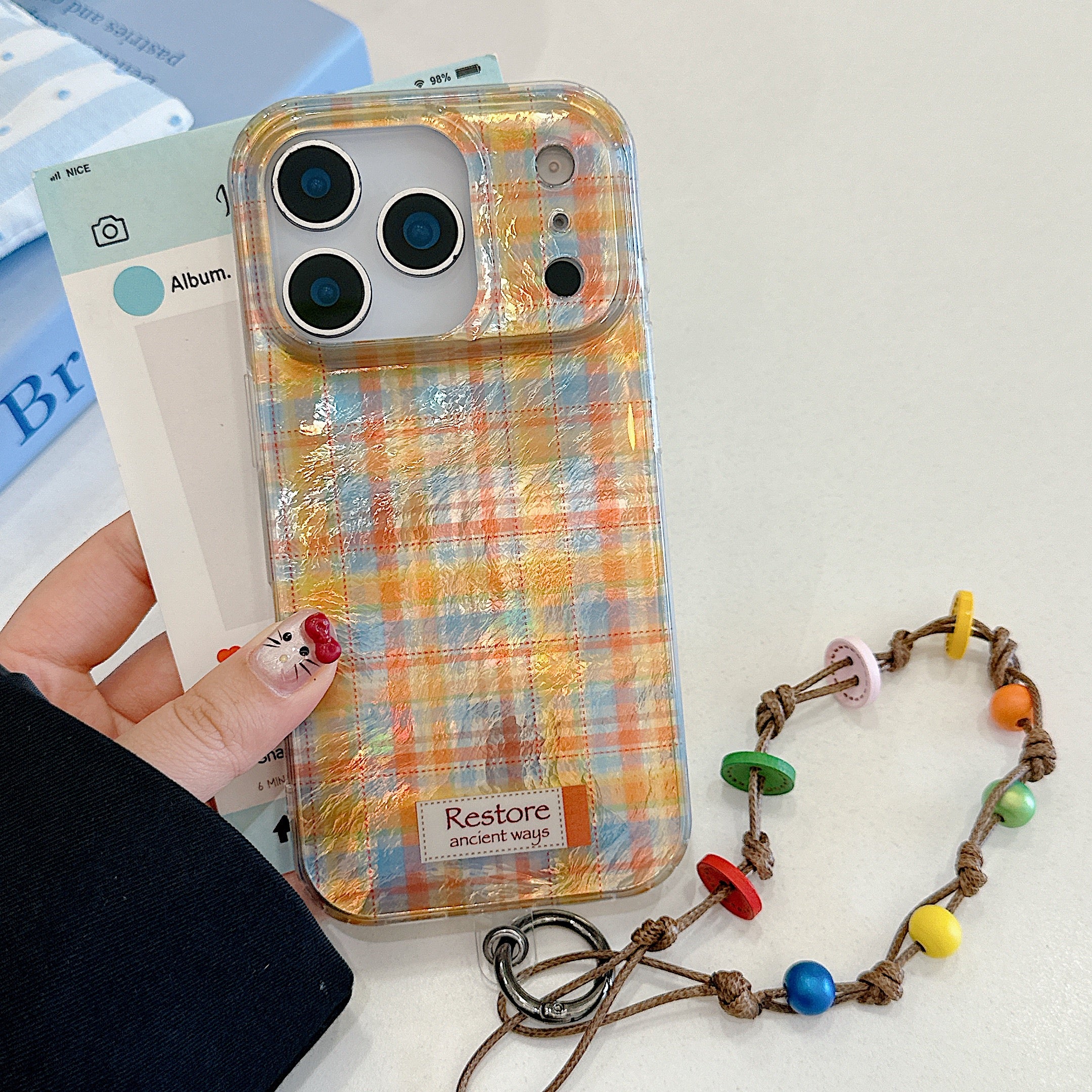 Purple and green checkered phone case with charm