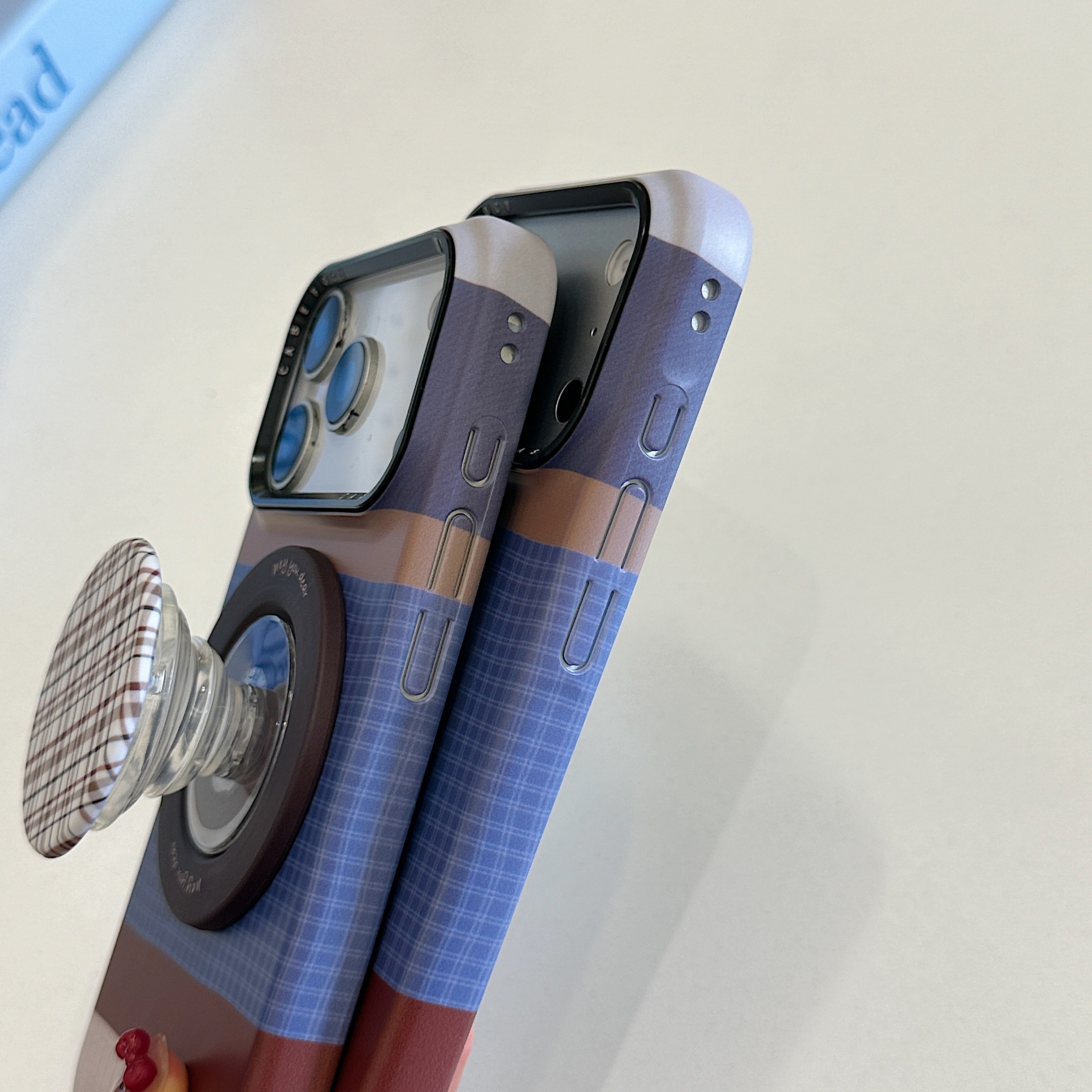 Brown, blue, and white striped phone case with magnetic stand