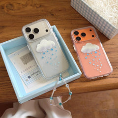 Hand holding the clear 3D cloud and blue star phone case over a pastel journal.