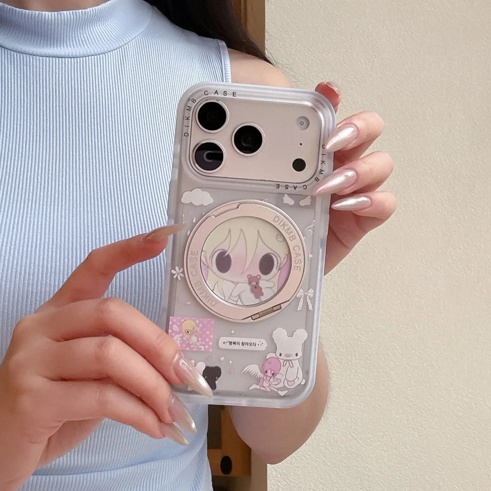 A cute Y2K anime phone case on a wooden table next to a slice of cake and a pink novel.