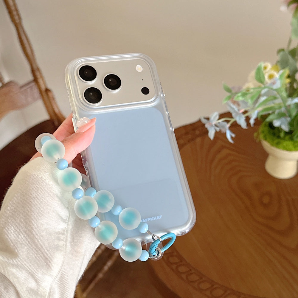 Hand holding an aesthetic blue iPhone cover with a clear bumper and a blue frosted beaded wristlet charm.