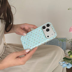 A woman holding an aesthetic blue striped iPhone case horizontally in her hands showing the silver camera plate.