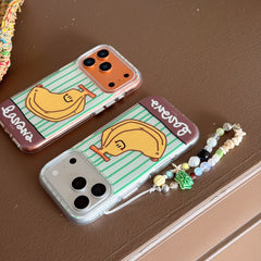 Two kawaii banana-themed iphone covers side by side on a brown table, one with a beaded wrist strap.