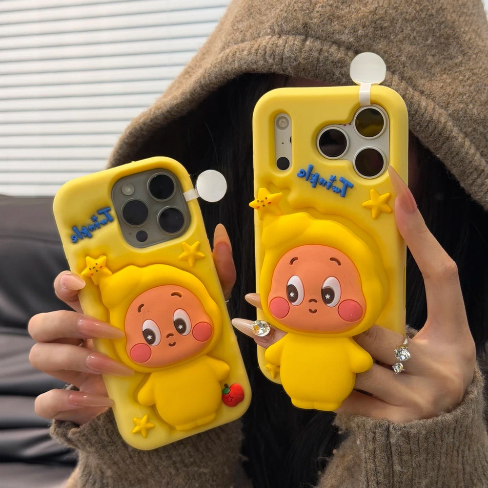 Two hands holding a pair of cute yellow silicone Twinkle Twinkle iPhone cases, paired with a cozy brown hooded knit sweater for a trendy Y2K aesthetic lifestyle look.