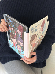 Side-by-side view of a Yoshitomo Nara iPad case being held open like a book, displaying the clear acrylic back with cartoon prints and a pink checkered spine.