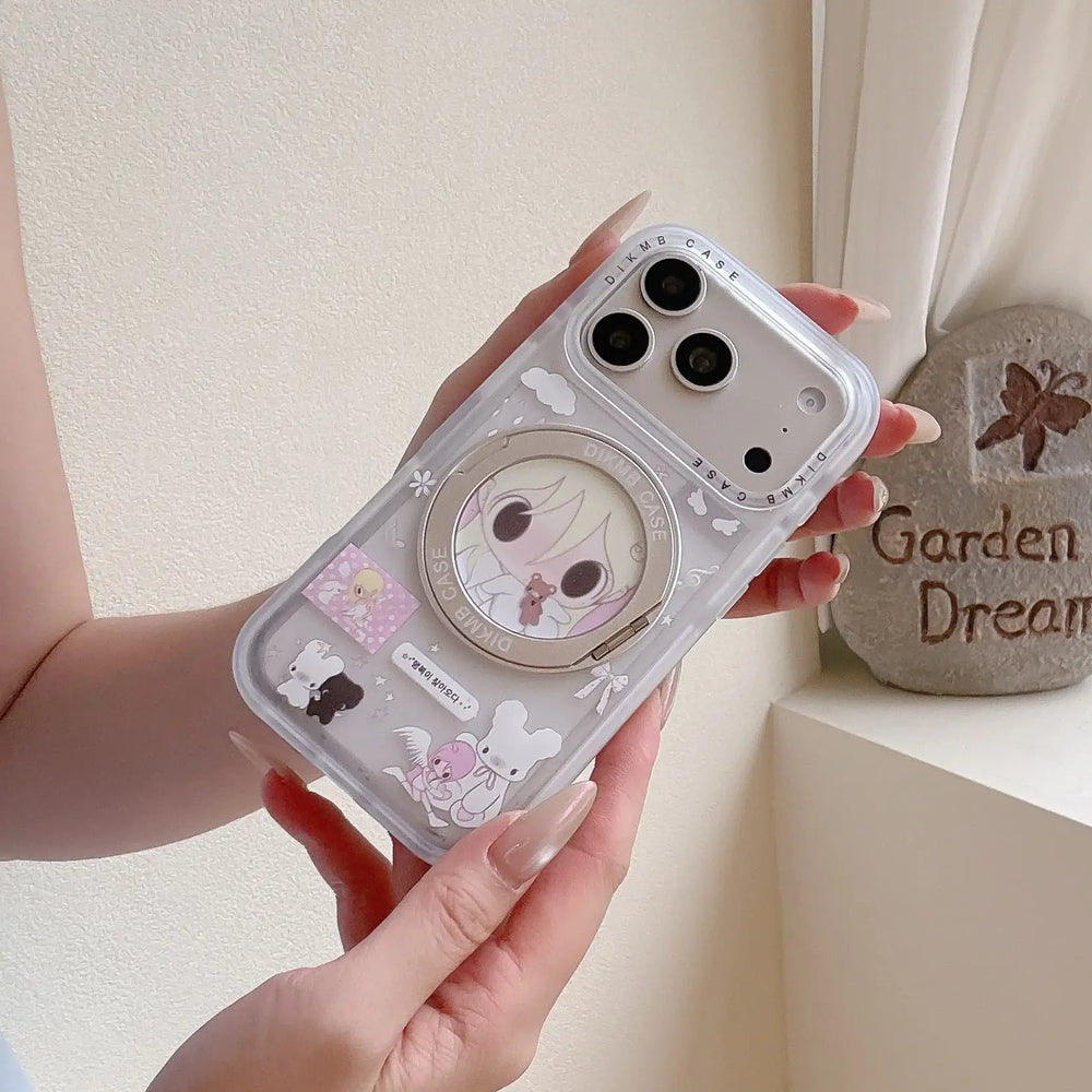 A clear anime girl iPhone case standing vertically on a wooden table supported by its silver ring kickstand.