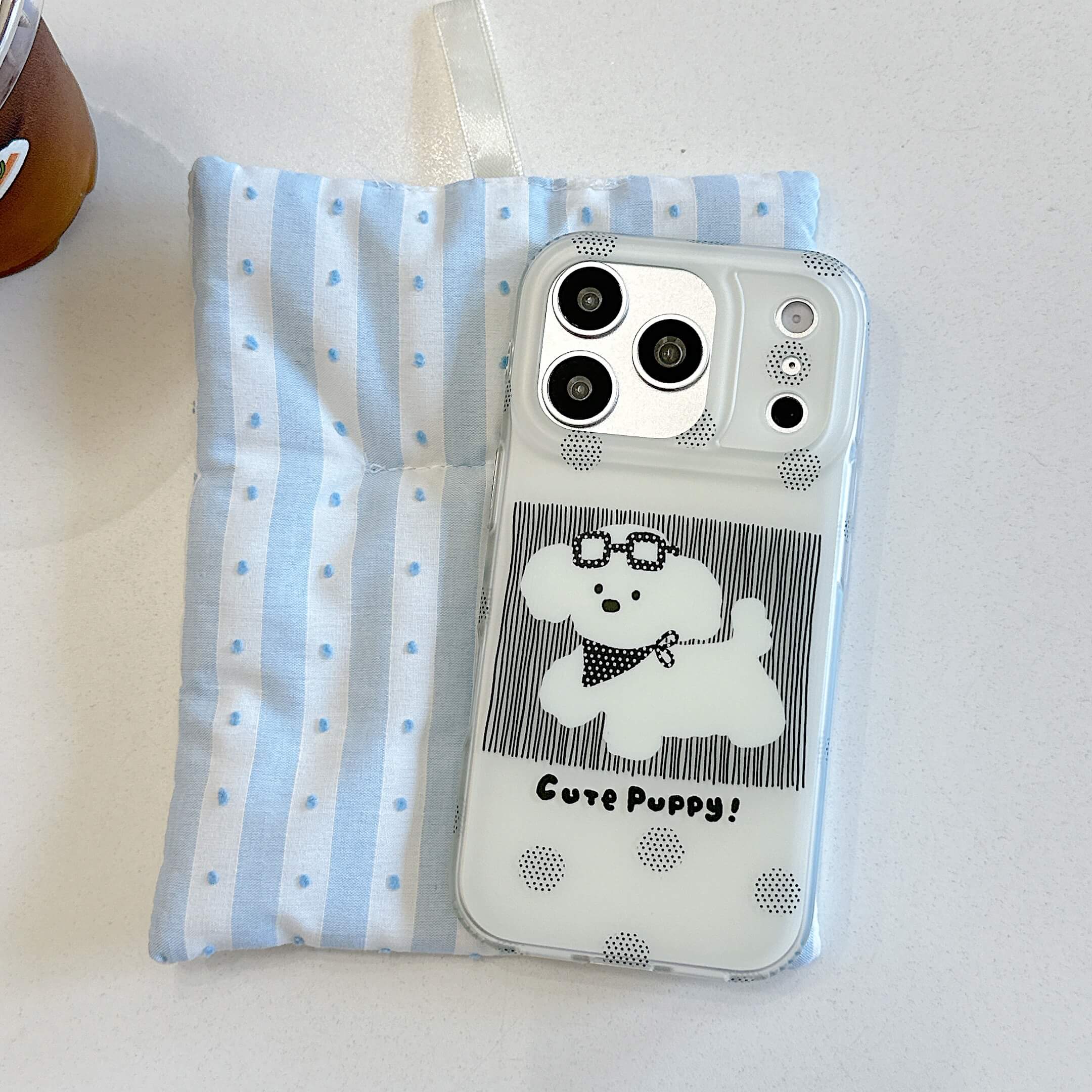 Black cute puppy iPhone case displayed on a blue striped pouch.