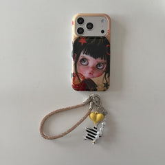 Black-haired big-eye doll iPhone case with heart and star charm wrist strap.