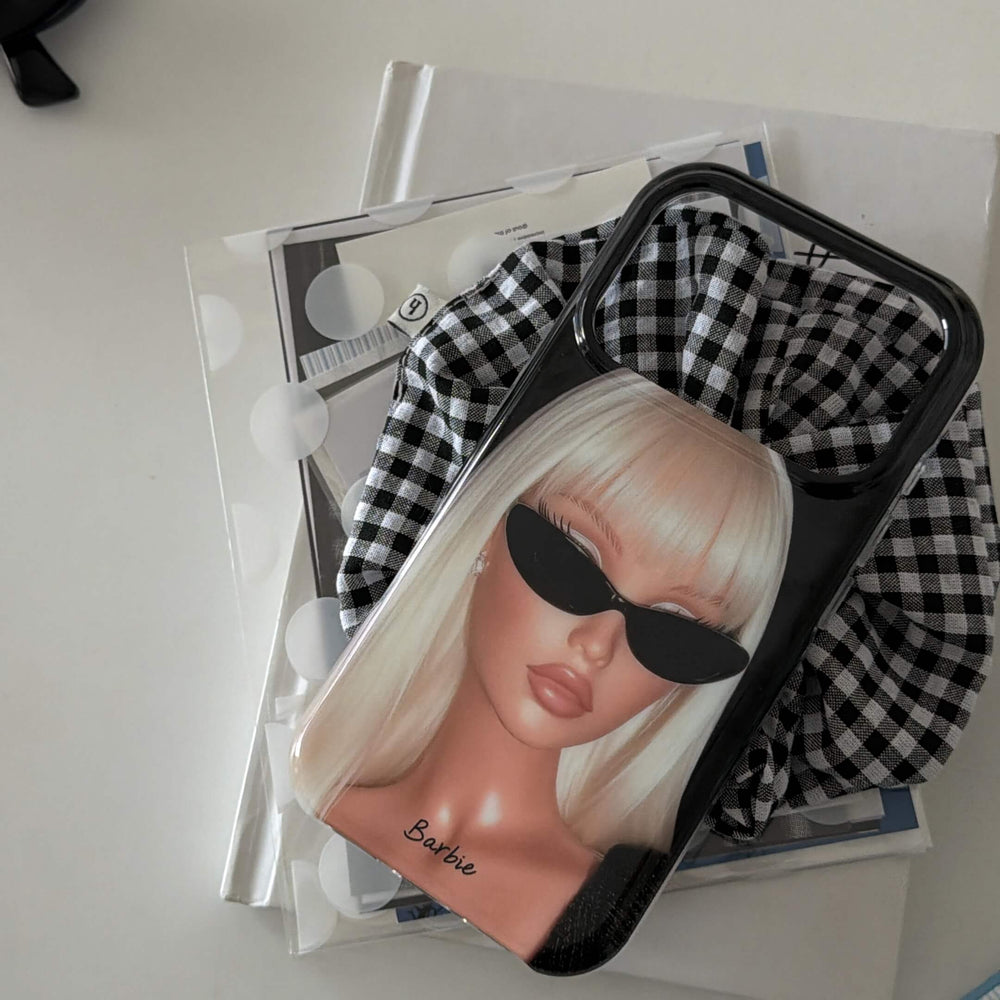 Y2K blonde girl iPhone case styled with books and gingham fabric.
