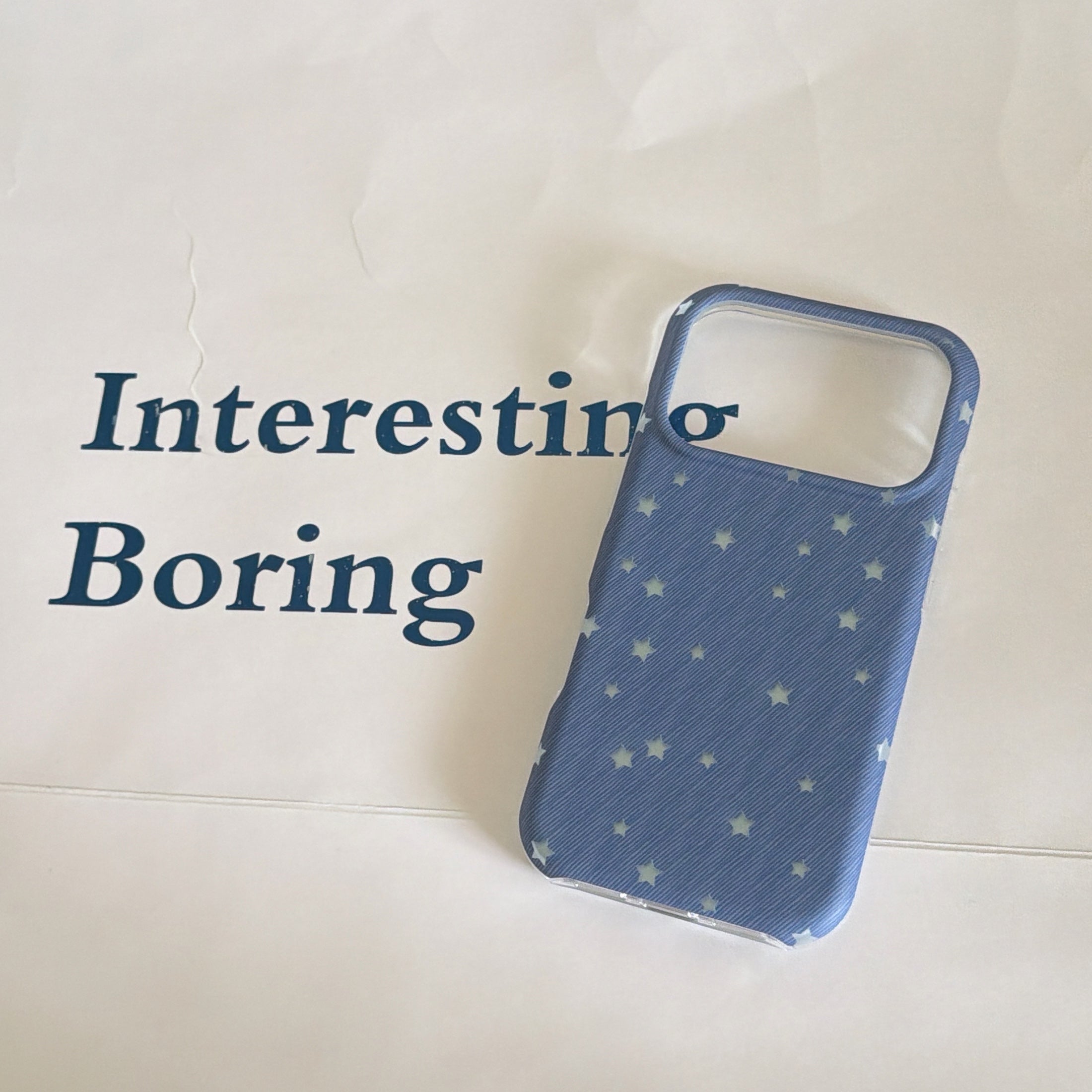 An empty blue textured star iPhone case shell highlighting its wide open camera module cutout.