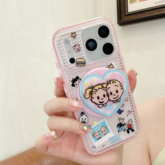 Hand holding a pink clear cartoon couple iPhone case with heart grip.