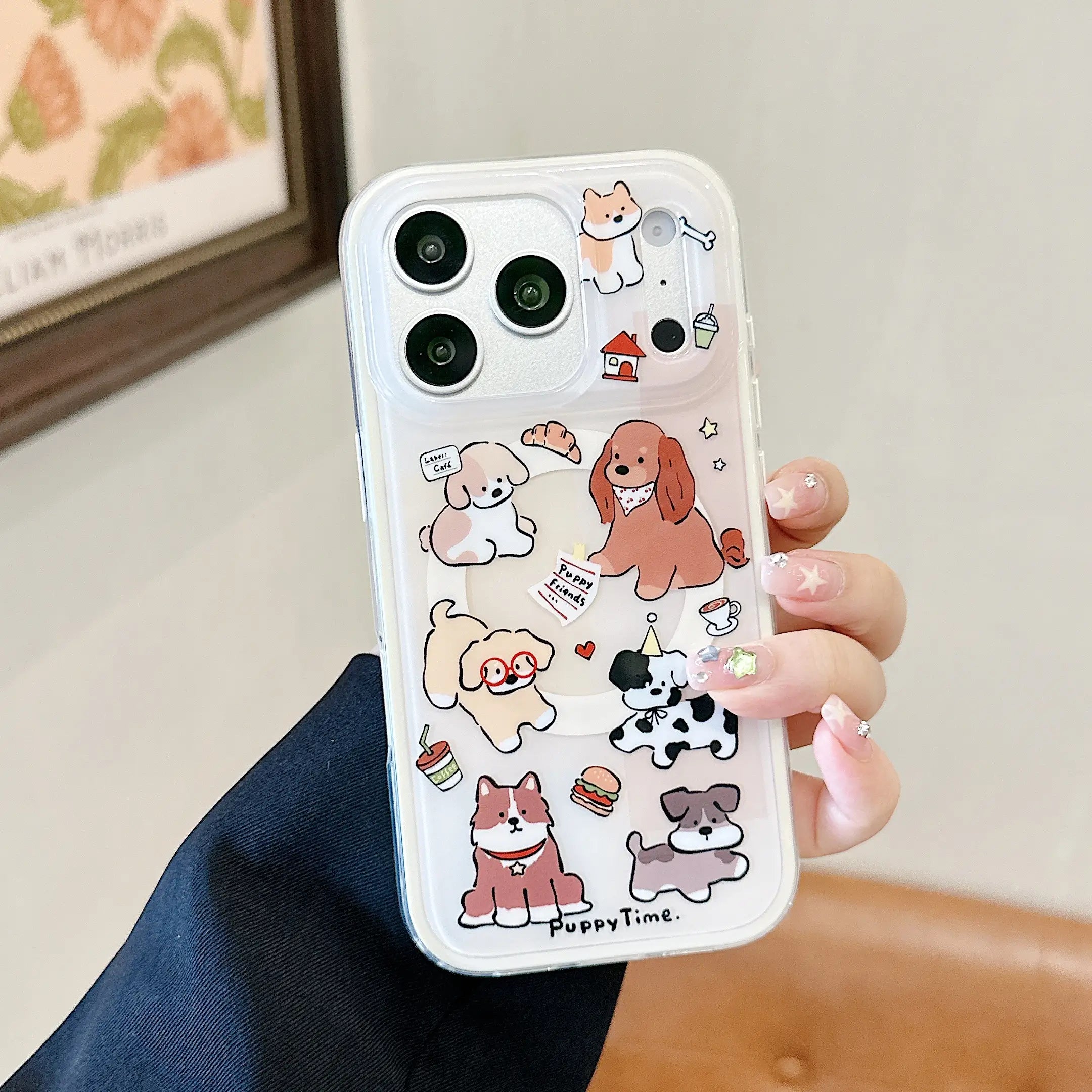 Clear cartoon dog iPhone case with rotating puppy grip shown beside iced coffee.