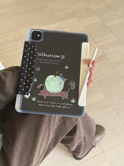 A person holding a clear back ipad case with pencil slot on their lap, displaying the funny sausage dog illustration on the back panel while holding a white Apple Pencil.