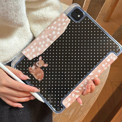 A close-up of a person holding an iPad clear back polka dot case with a built-in pencil holder and an adorable little deer character design.