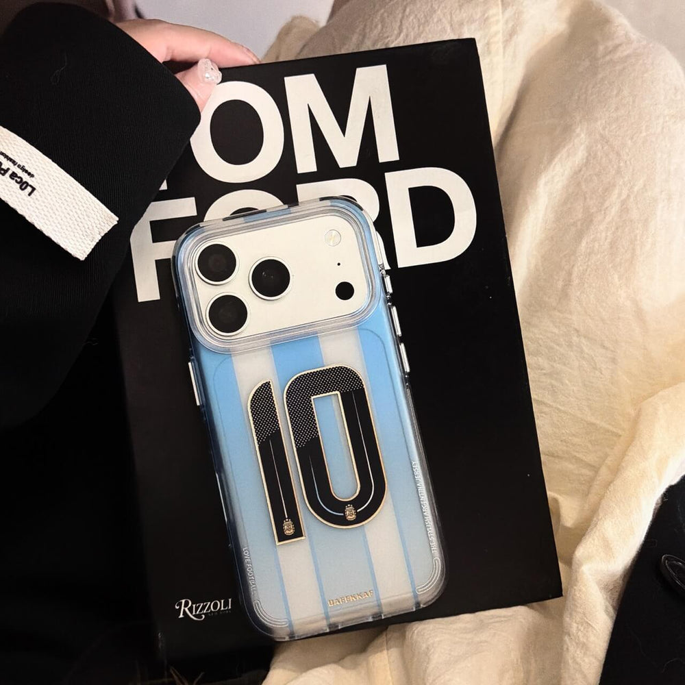 Clear blue striped soccer iPhone case with No.10 graphic displayed on a book