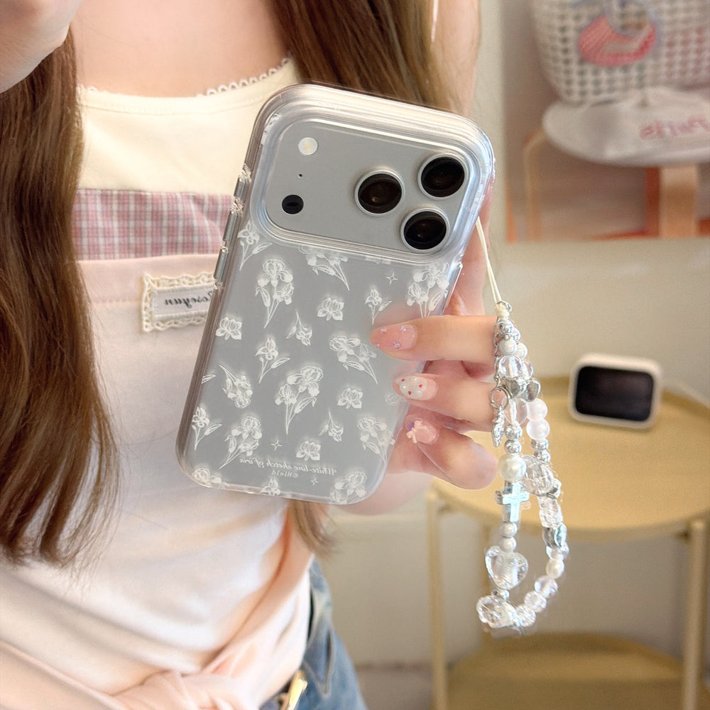 Close-up of a transparent iPhone case featuring a white botanical iris print and a silver glitter camera border.