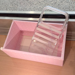 A clear vertical striped phone case shell with a pink rhinestone Angel script design showcased inside a pastel pink polka dot gift box.