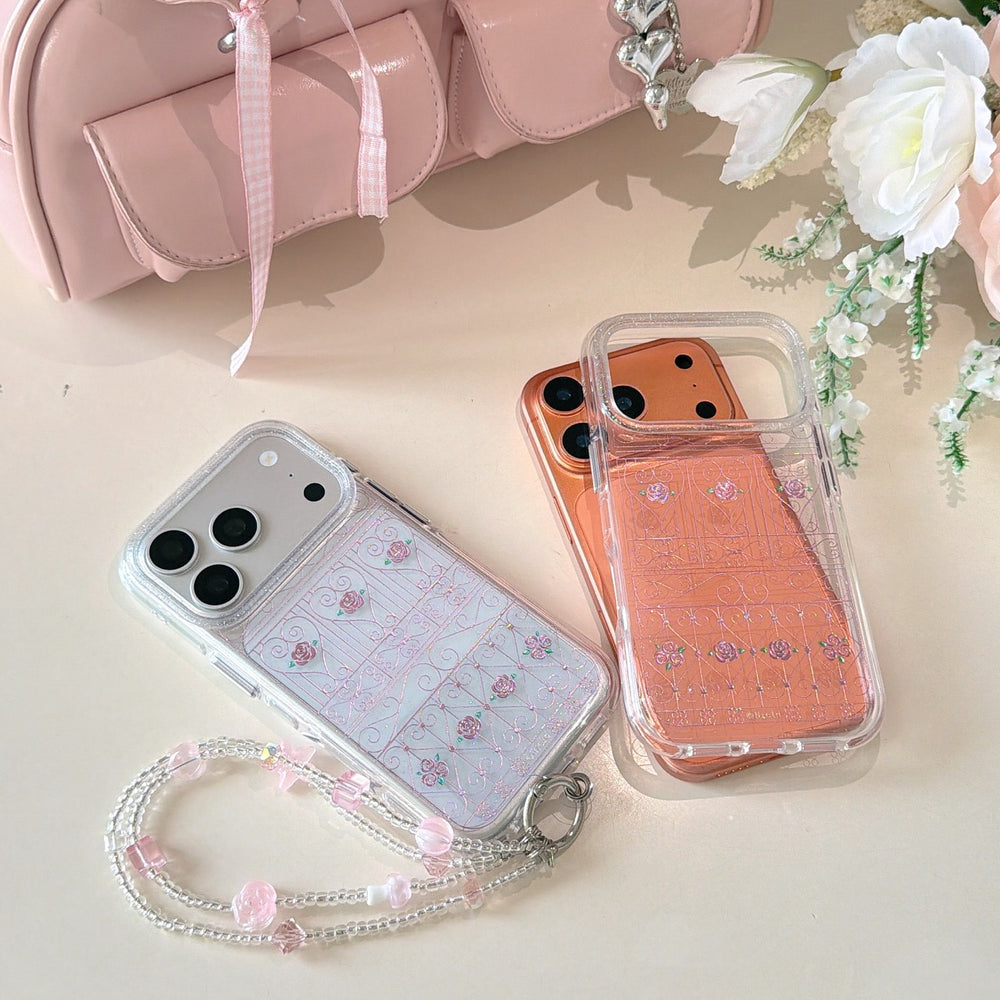 Silver and orange floral gate phone cases displayed next to a pink handbag and white flowers.