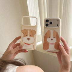 Two cozy hand-drawn puppy iPhone case designs held beside a bright window.