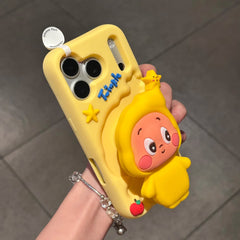 Handheld perspective view of the protective yellow silicone Pop Mart Twinkle Twinkle phone case, highlighting the premium tactile 3D raised texture of the starry art toy character and flexible camera frame.