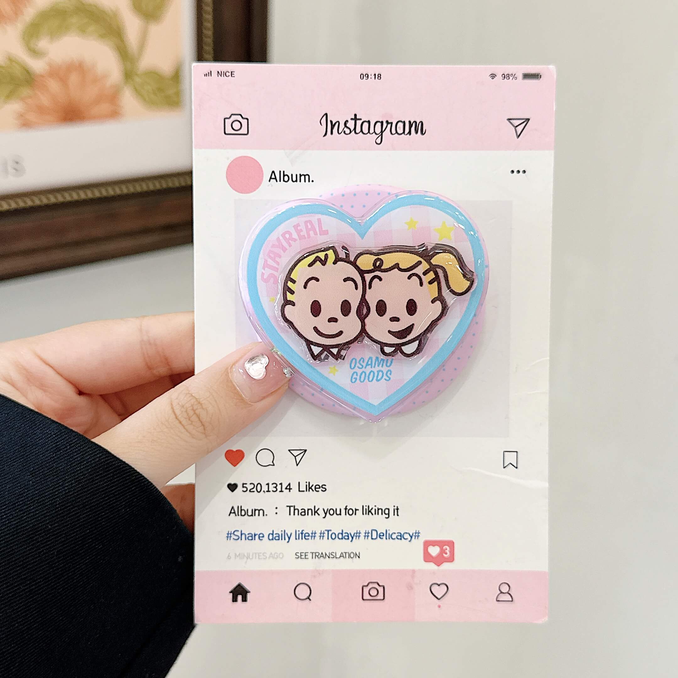 Lifestyle view of pink cartoon couple iPhone case with heart grip.