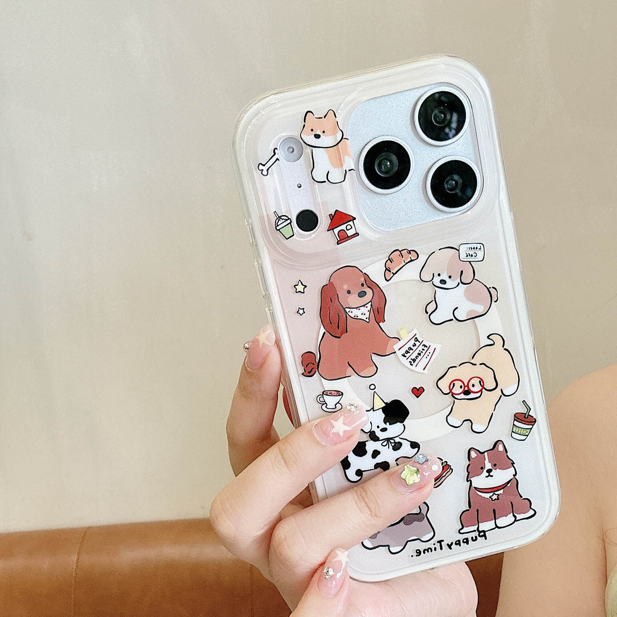 Hand holding a clear cute cartoon dog iPhone case with colorful puppy print.