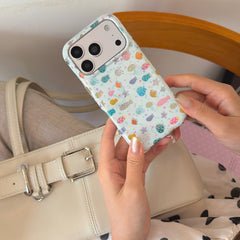 Close-up view of hands holding a cute cartoon fish clear iPhone case with raised silver camera frame.