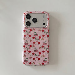 Flat lay back view of a cute cherry pink iPhone case with floral patterns on a white surface.