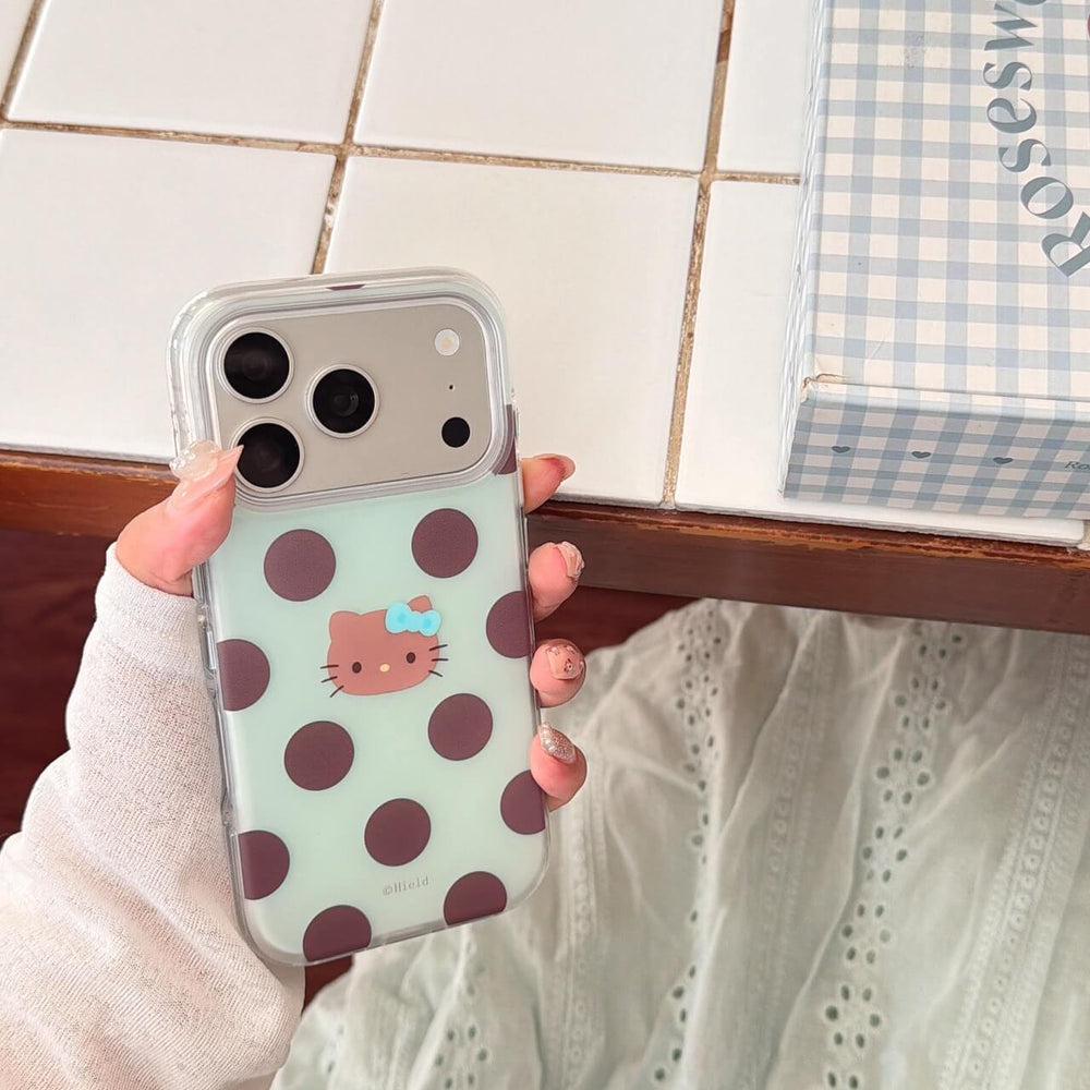 Hand holding mint polka dot clear iPhone case with cute kitty face
