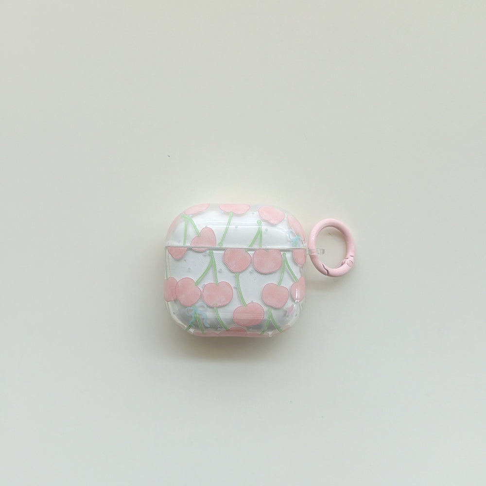 A front centered view of a cute clear AirPods case with a pink cherry pattern and a matching pink ring.