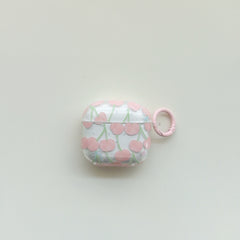 A front centered view of a cute clear AirPods case with a pink cherry pattern and a matching pink ring.