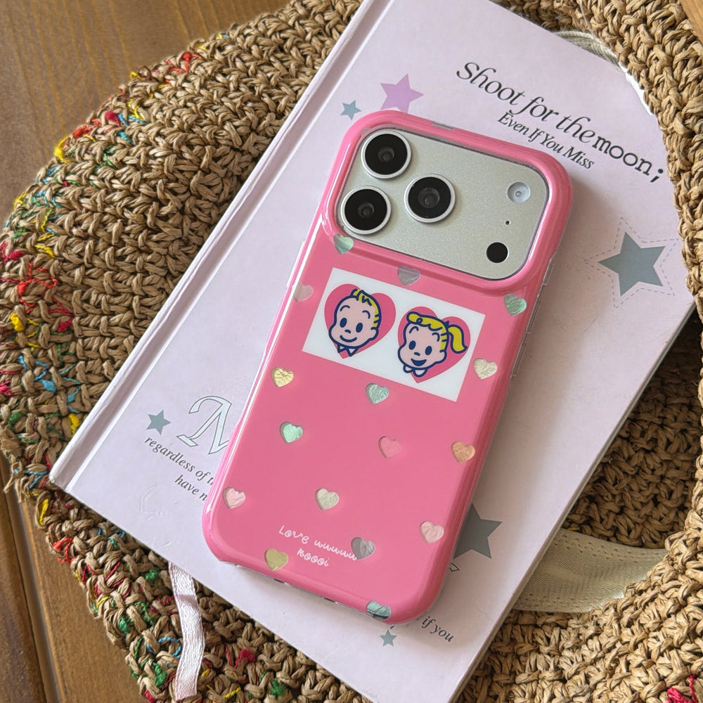 A cute pink Osamu Goods phone case resting on a pastel notebook inside a woven straw hat.