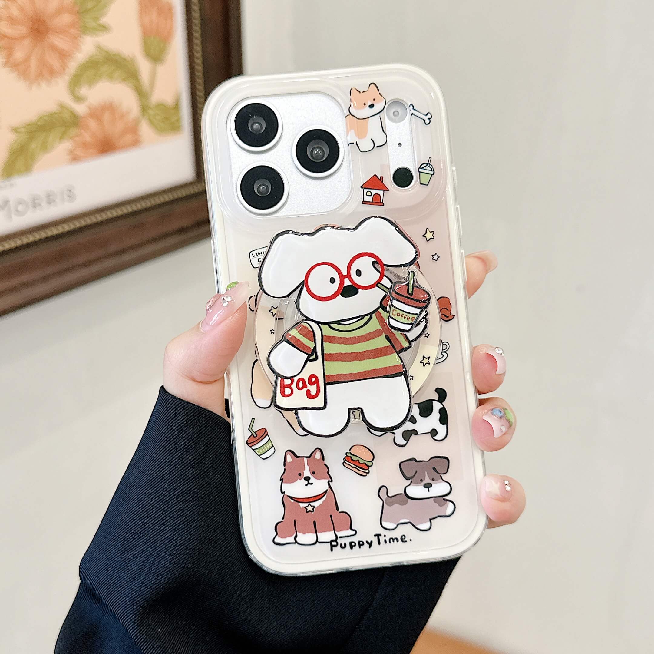 Close-up of a clear cute puppy iPhone case with a red glasses rotating phone grip.