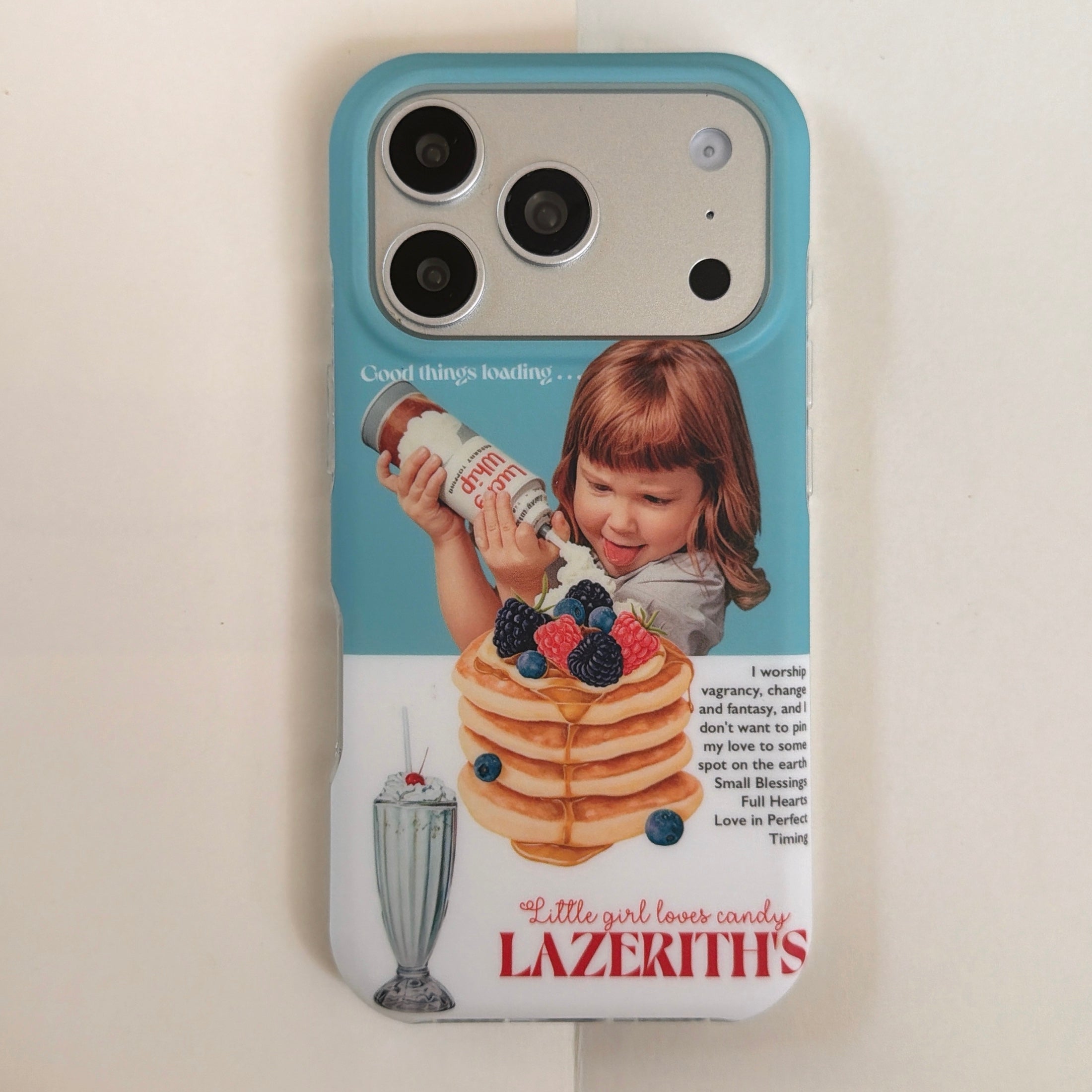 A flat lay front view of a cute retro girl pancakes iPhone case with a blue camera bumper.