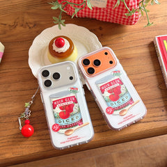 Silver and orange tomato soup can phone covers displayed next to a caramel pudding dessert.