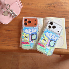 Top view of silver and bronze iPhones wearing cute cat doodle clear cases placed on an open diary.