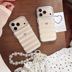 Two gray striped clear iPhone cases with heart accents on wooden table