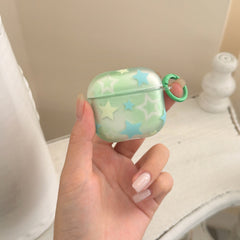 A hand holding a cute translucent mint green AirPods Pro case with a pattern of pastel blue and yellow stars.