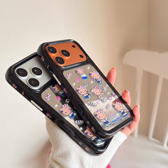A hand displaying two color options of the Hello Kitty mirror phone case showing the orange and silver camera bumpers.