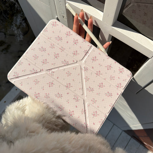 A premium textured cream iPad case with apple pencil holder held under bright sunlight next to a white window frame.