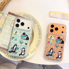 A pastel green and an orange Korean style cat illustration mirror phone case placed on a vintage yellow French text plate.