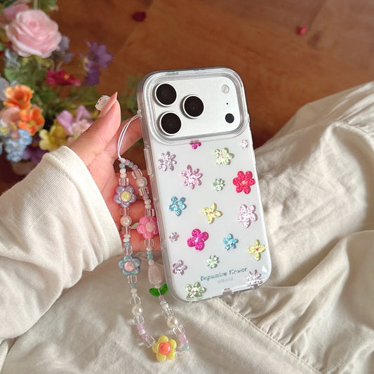 A hand holding a kawaii flower clear case with a beaded lanyard against a linen fabric background.