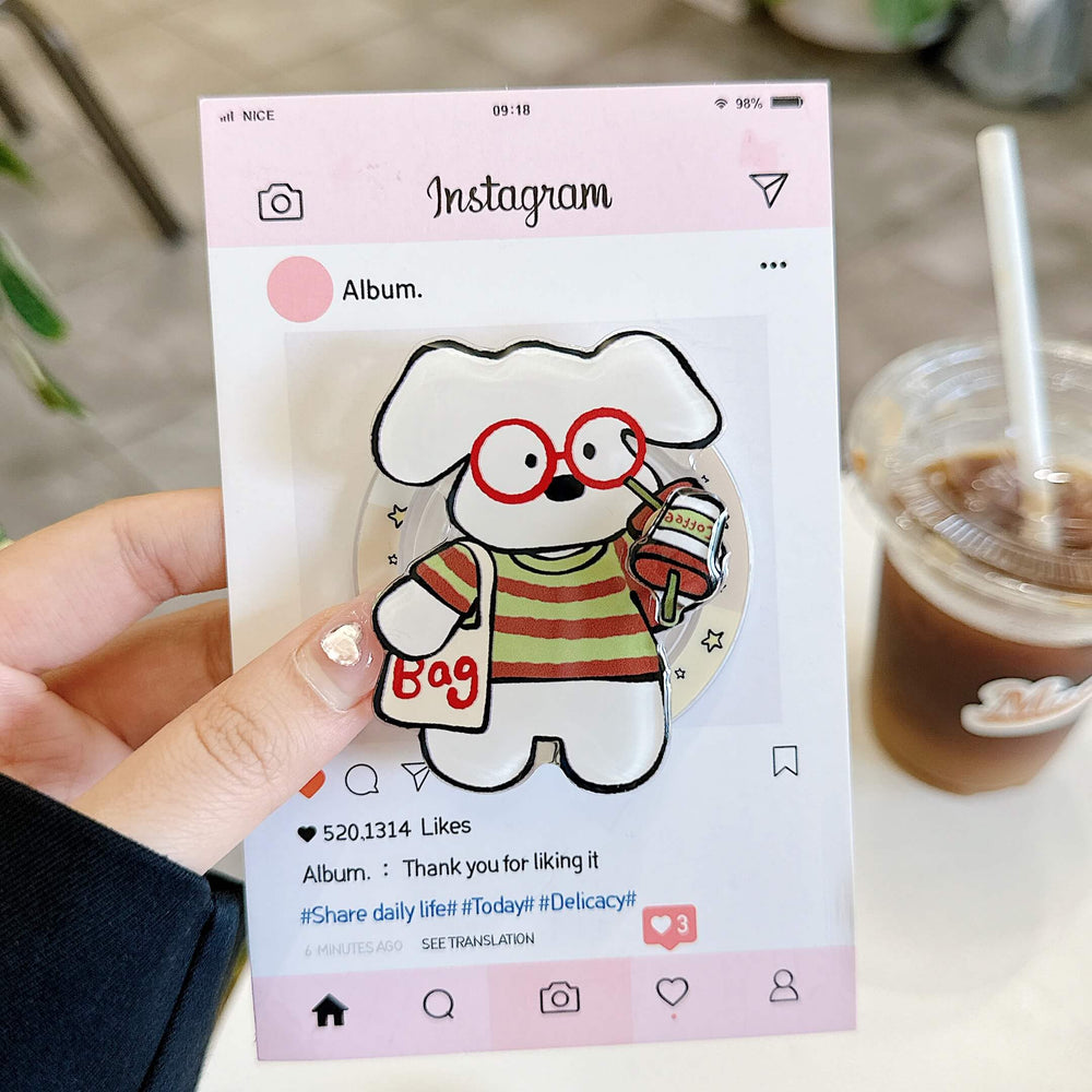 Hand holding a clear kawaii pet iPhone case with colorful cartoon puppy artwork.