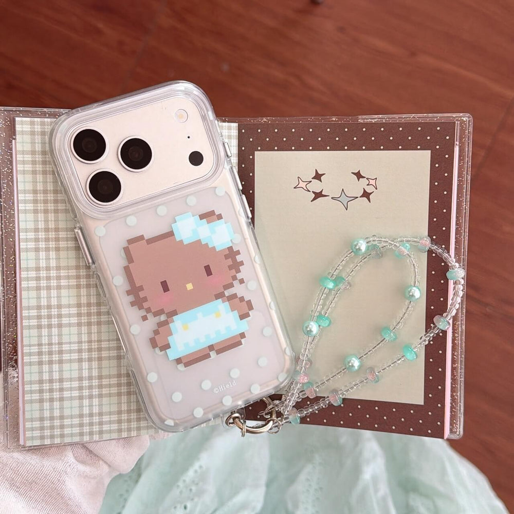 Kawaii pixel kitty iPhone case with polka dots displayed on a journal