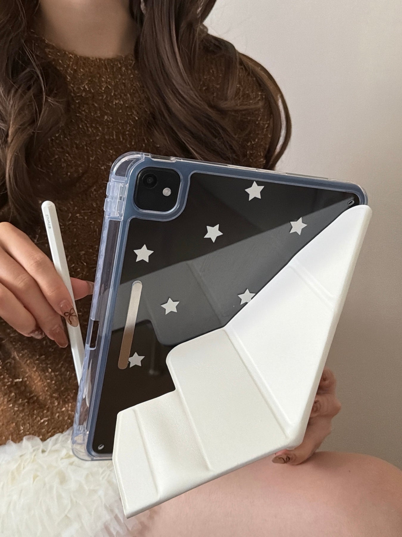 Rear view of the Koooi iPad case folded into a vertical portrait origami stand, showing the white smart cover supporting the clear starry back panel.