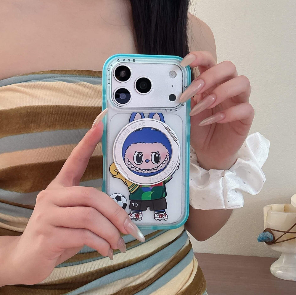 A woman holding a cute Labubu soccer iPhone case in front of her striped dress.